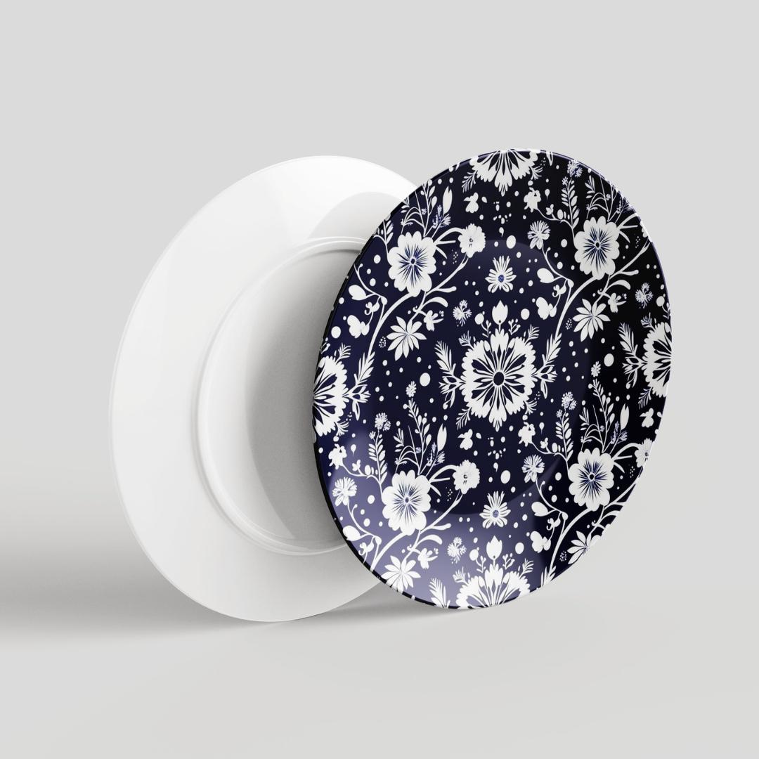 A zoomed-in view of Earn Her Way&#39;s ceramic plate’s intricate floral design, showcasing the fine details and vibrant colors. Navy and white ceramic plate