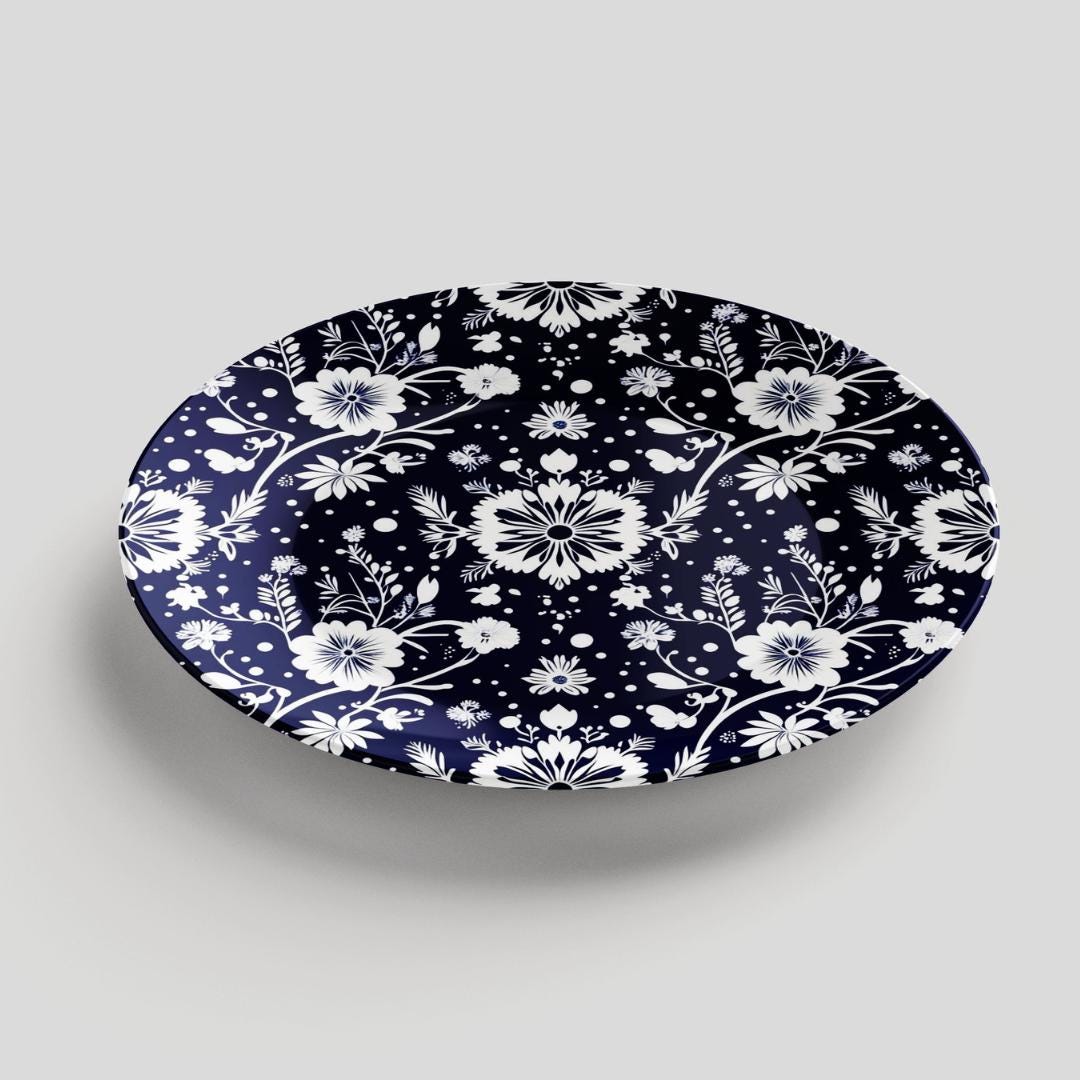 Navy and white elegant round decorative plate featuring a handcrafted floral design with delicate botanical patterns, perfect for dining or kitchen decor.