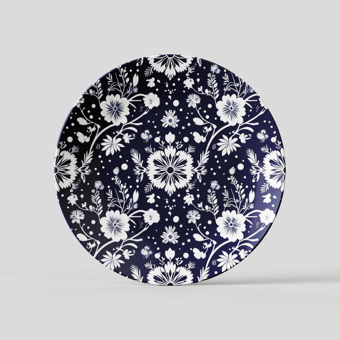 Navy and white round decorative plate featuring a handcrafted floral design with delicate botanical patterns, perfect for dining or kitchen decor.